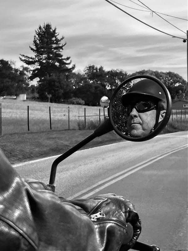 Picture of Ed Lane in the a motorcycle mirror